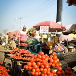 A Nigerian market scene symbolizing economic hardship and Christian trust in God