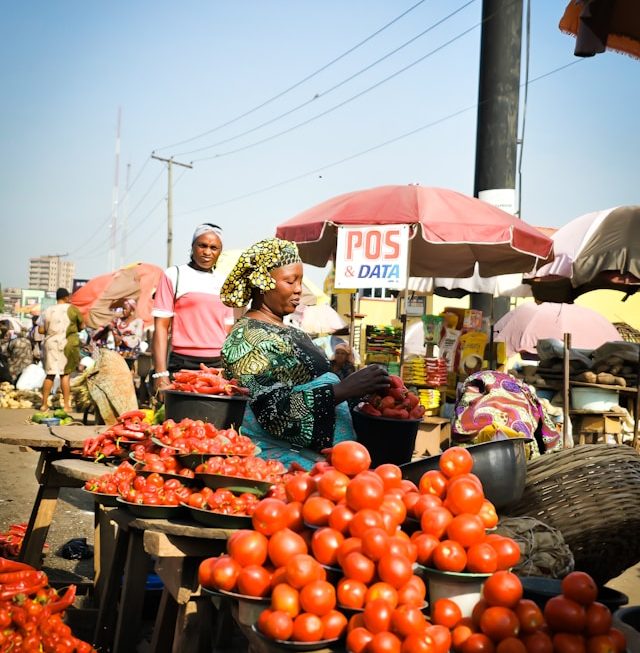 A Nigerian market scene symbolizing economic hardship and Christian trust in God